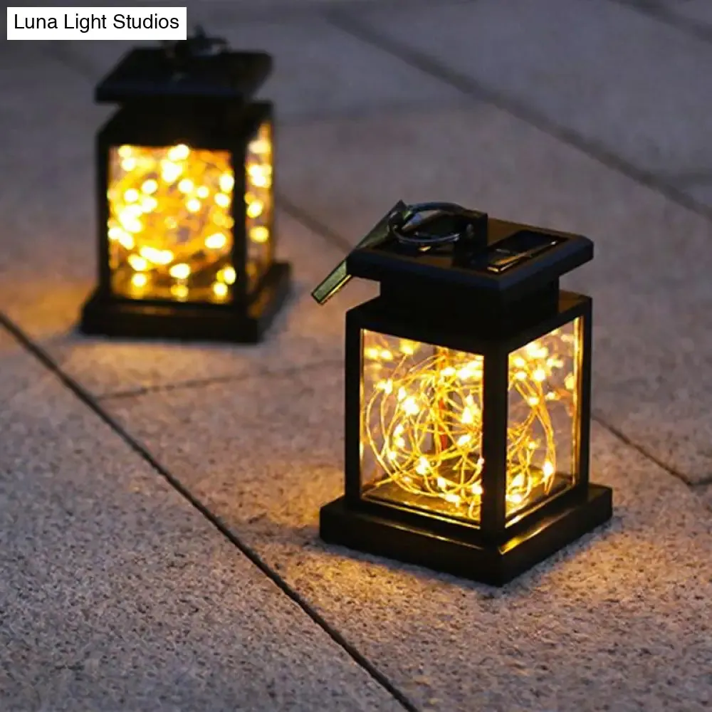 Artistic Black LED Solar Lantern Pendant Light with Clear Glass, Clamp, and Hook